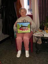 Mary Lou Taylor with her painting of Courtney Road Service Station, Henrico County, Virginia.