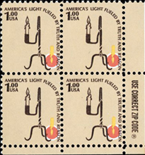 This commemorative postage stamp depicts a hand-forged rush light.