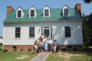 APHA members pose on the steps of the restored Springdale farmhouse.