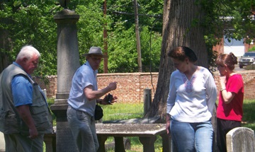 Michelle and Len Jolley visit the grave of John Cussons at Hollywood Cemetery.