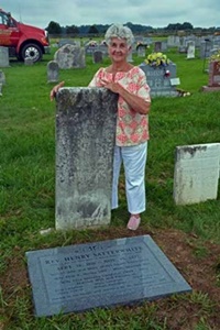 Dot Chewning, standing next to grave of Rev. Henry Satterwhite.