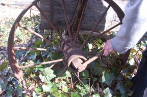Wagon wrench removing nut securing wheel to axle of farm wagon.