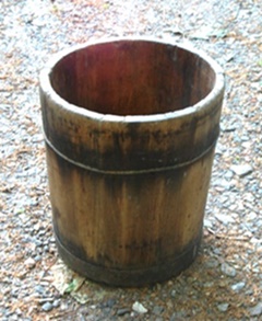 Wooden semi-conical container.