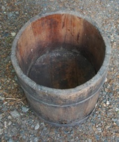Wider top of wooden semi-conical container.