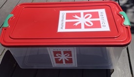 Book collection bin with Henrico Christmas Mother logo.